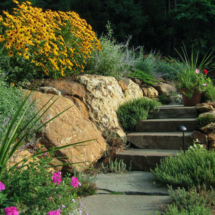 Photo of a mid-sized traditional sloped full sun formal garden for summer in New York with a garden path and natural stone pavers.