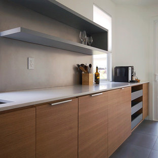 Large midcentury modern kitchen pantry ideas - Inspiration for a large midcentury modern single-wall ceramic floor kitchen pantry remodel in Orange County with an undermount sink, flat-panel cabinets, medium tone wood cabinets, quartz countertops, metallic backsplash, stainless steel appliances, metal backsplash and an island