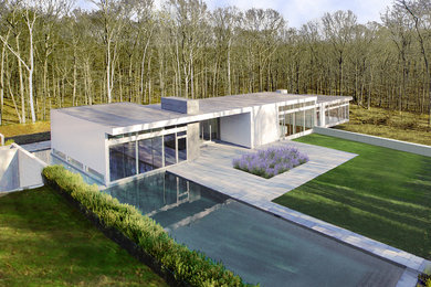 Large modern white two-story exterior home idea in New York