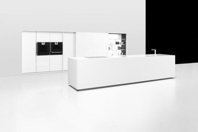 Kitchen - contemporary kitchen idea in Amsterdam with an island, flat-panel cabinets, white cabinets and an integrated sink