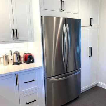 Ikea white cabinets with subway tile backsplash and floating shelves
