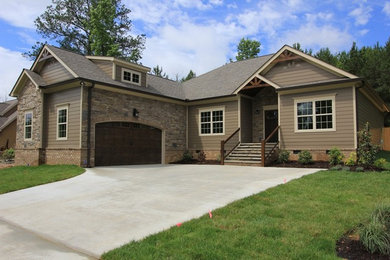 Mid-sized elegant brown one-story mixed siding gable roof photo in Other