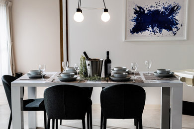 Scandinavian dining room in Other with white walls.