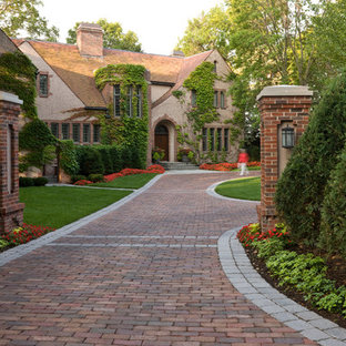 Inspiration for a traditional front yard driveway in Minneapolis with brick pavers and with lawn edging.