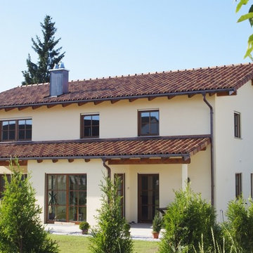 Massiv-Holzhaus mit Putzfassade im Toskana Stil