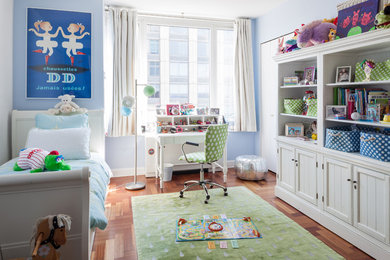 Large eclectic girl medium tone wood floor kids' room photo in New York with blue walls