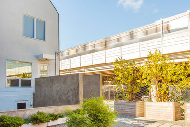 Large contemporary gray three-story stucco gable roof idea in Chicago