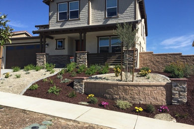 This is an example of a mid-sized transitional partial sun front yard gravel garden path in San Diego for spring.