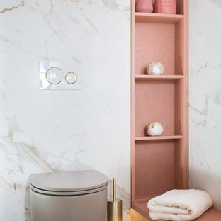 Inspiration for a small contemporary master black and white tile and porcelain tile porcelain floor and white floor walk-in shower remodel in Tel Aviv with furniture-like cabinets, a wall-mount toilet, white walls, a console sink, wood countertops, a hinged shower door, pink countertops and distressed cabinets