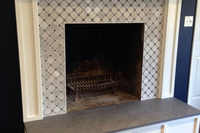 Inspiration for a mid-sized transitional enclosed living room remodel in Philadelphia with blue walls, a standard fireplace and a tile fireplace