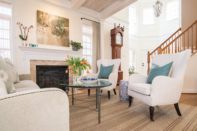 Inspiration for a transitional medium tone wood floor and brown floor living room remodel in DC Metro with beige walls, a standard fireplace and a stone fireplace