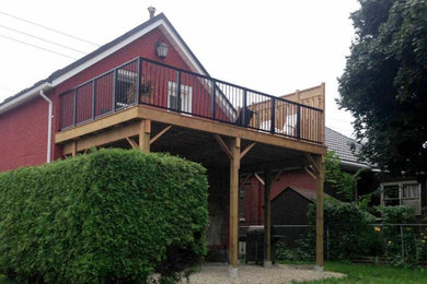 Deck - mid-sized traditional backyard deck idea in Other with no cover
