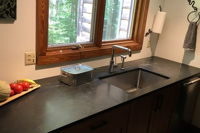 Enclosed kitchen - large contemporary single-wall enclosed kitchen idea in Nashville with an undermount sink, flat-panel cabinets, medium tone wood cabinets, granite countertops, white backsplash and stainless steel appliances