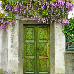 Photo of an eclectic front door in Cornwall with multi-coloured walls, a single front door and a metal front door.