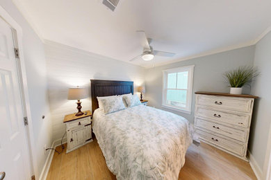 Mid-sized beach style master porcelain tile and brown floor bedroom photo in Birmingham with blue walls