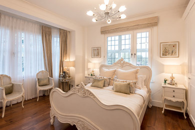 Example of a mid-sized classic bedroom design in London
