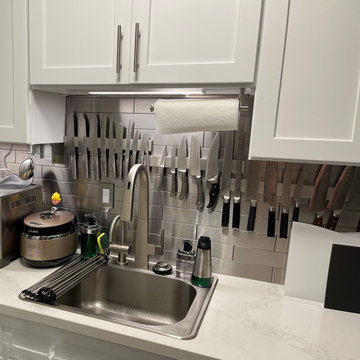 San Francisco area White Kitchen with Stainless Steel Backsplash