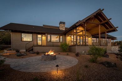 Inspiration for a mid-sized modern backyard brick patio remodel in Other with a fire pit and a roof extension