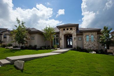 Large transitional beige two-story mixed siding exterior home photo in Austin with a hip roof