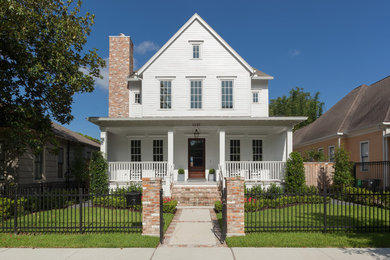 Photo of a traditional three-storey white house exterior in Houston with wood siding, a gable roof and a shingle roof.