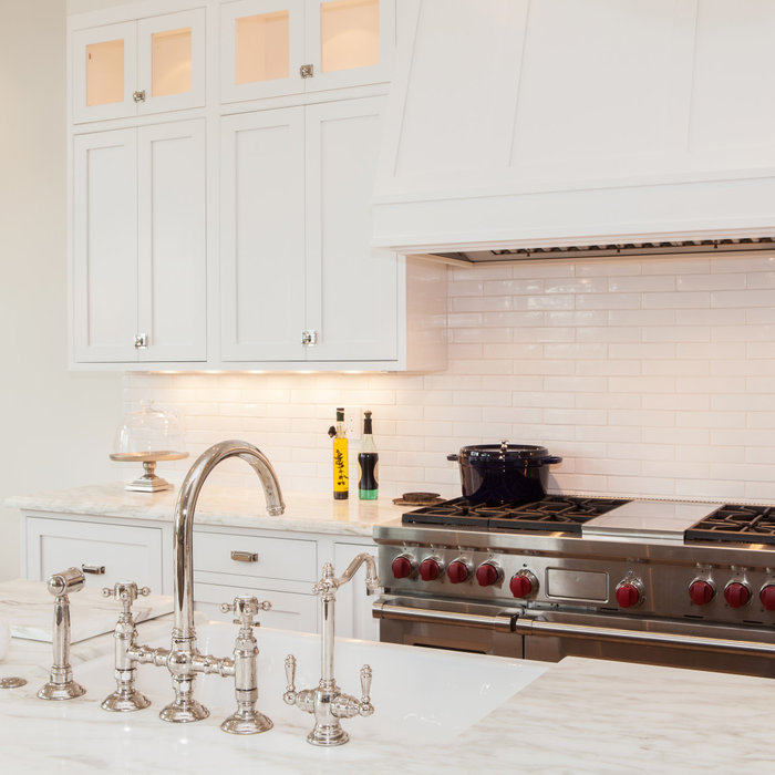 Example of a transitional kitchen design in San Francisco with a farmhouse sink, recessed-panel cabinets, white cabinets, marble countertops, white backsplash, subway tile backsplash and stainless ste