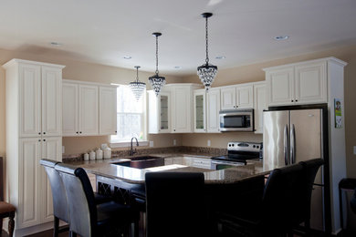 Example of a minimalist open concept kitchen design in Detroit with white cabinets