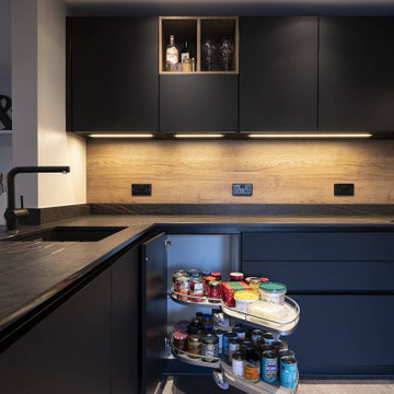 Black handleless kitchen with black marble worktop