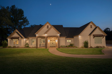 Photo of a large arts and crafts one-storey brick white house exterior in Dallas with a gable roof and a shingle roof.