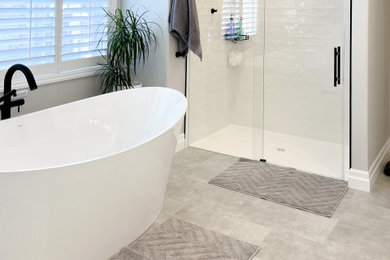 Large transitional master white tile and ceramic tile porcelain tile, gray floor and double-sink bathroom photo in Toronto with shaker cabinets, white cabinets, a bidet, gray walls, an undermount sink, quartz countertops, white countertops and a built-in vanity