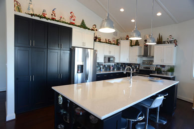 Inspiration for a large transitional l-shaped dark wood floor eat-in kitchen remodel in Kansas City with an undermount sink, black cabinets, multicolored backsplash, stainless steel appliances, shaker cabinets, quartz countertops, ceramic backsplash and an island