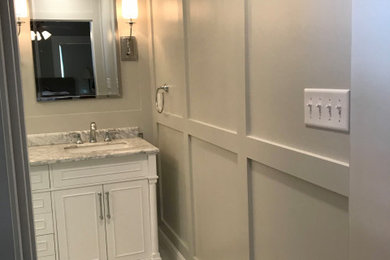 Example of a transitional master porcelain tile white floor, double-sink and wainscoting double shower design in Houston with beaded inset cabinets, white cabinets, gray walls, marble countertops, a hinged shower door, white countertops, a niche and a freestanding vanity