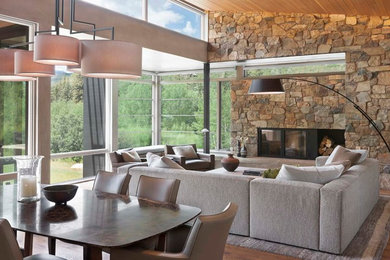 Inspiration for a large contemporary open concept medium tone wood floor living room remodel in Denver with a standard fireplace, a stone fireplace and no tv