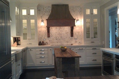 Photo of a traditional kitchen in Raleigh with a farmhouse sink, recessed-panel cabinets, beige cabinets, marble benchtops and with island.