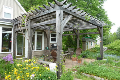 Patio - traditional patio idea in Other with a pergola