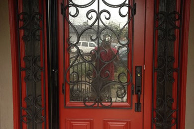 Entryway photo in Los Angeles with brown walls and a red front door