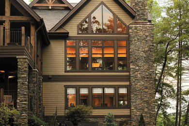 Large rustic brown two-story wood exterior home idea in Other with a shingle roof