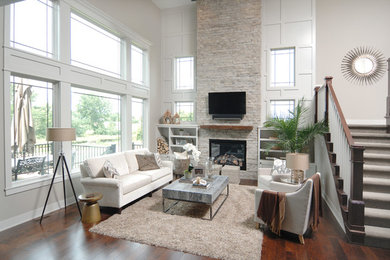Mid-sized transitional open concept dark wood floor family room photo in Other with white walls, a standard fireplace, a stone fireplace and a wall-mounted tv