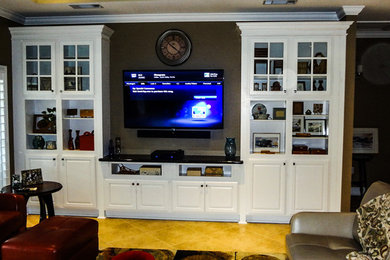 Inspiration for a mid-sized timeless living room remodel in New Orleans with brown walls and a wall-mounted tv