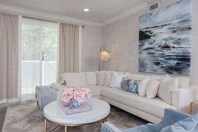 Inspiration for a mid-sized transitional open concept medium tone wood floor and brown floor living room remodel in Los Angeles with gray walls, a wall-mounted tv and no fireplace