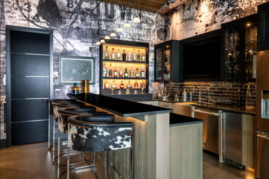 Trendy u-shaped gray floor seated home bar photo in Minneapolis with shaker cabinets, medium tone wood cabinets, black backsplash, subway tile backsplash and black countertops