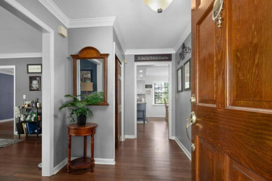 Inspiration for a mid-sized timeless dark wood floor and brown floor entryway remodel in Columbus with gray walls and a dark wood front door