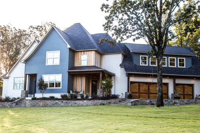 Large eclectic blue two-story concrete fiberboard exterior home photo in Little Rock with a hip roof