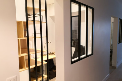 Cette image montre un bureau design de taille moyenne avec un mur blanc, sol en stratifié, un bureau intégré et un sol beige.