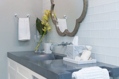 Example of a trendy blue tile and glass tile walk-in shower design in San Francisco with an integrated sink, furniture-like cabinets, white cabinets, concrete countertops and a one-piece toilet