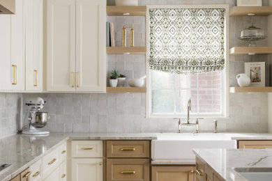Inspiration for a mid-sized transitional l-shaped light wood floor and brown floor eat-in kitchen remodel in Dallas with a farmhouse sink, recessed-panel cabinets, light wood cabinets, quartzite countertops, white backsplash, ceramic backsplash, paneled appliances, an island and white countertops