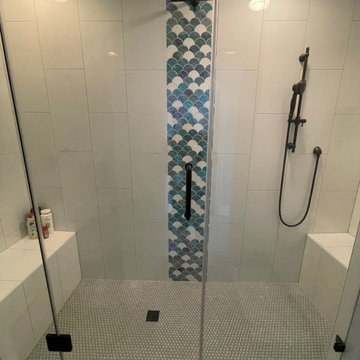 Beautiful bathroom with vertical 12x24 white tiles and a scallop waterfall.