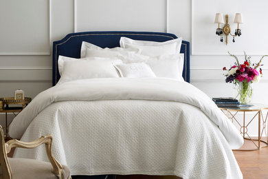 Large cottage chic master light wood floor bedroom photo in Other with white walls