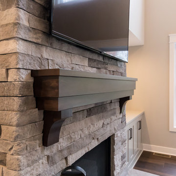 Living Room Remodel Featuring a Ledgestone Fireplace + Cabinetry + Shaw Coretec