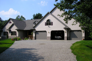 Large traditional brown one-story vinyl and clapboard exterior home idea in Other with a shingle roof and a brown roof