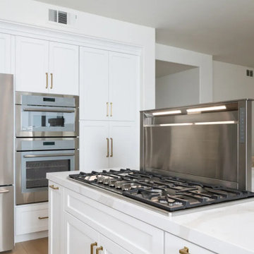 A cooktop with a convertible downdraft range hood